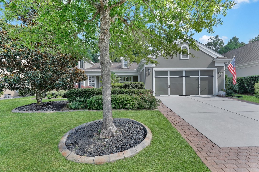 Beautiful Lilac model home featuring lush landscap