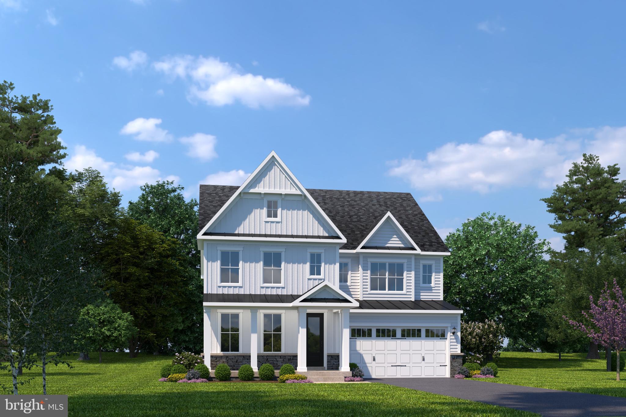 a front view of residential houses with yard and green space