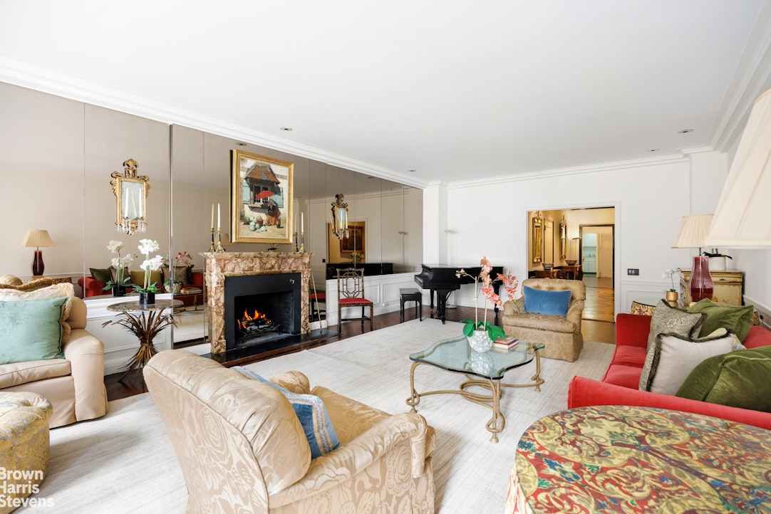 a living room with furniture fireplace and a table