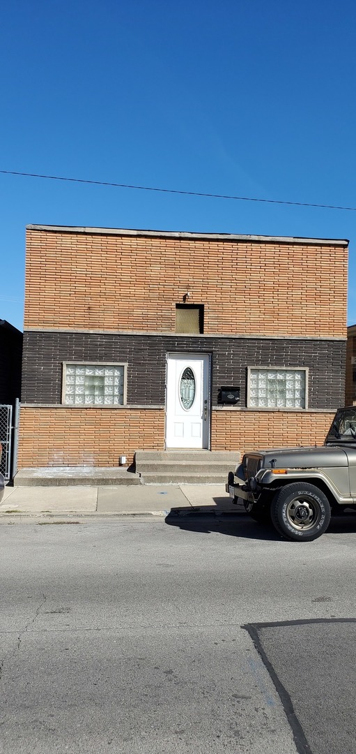 a front view of a house with a parking space