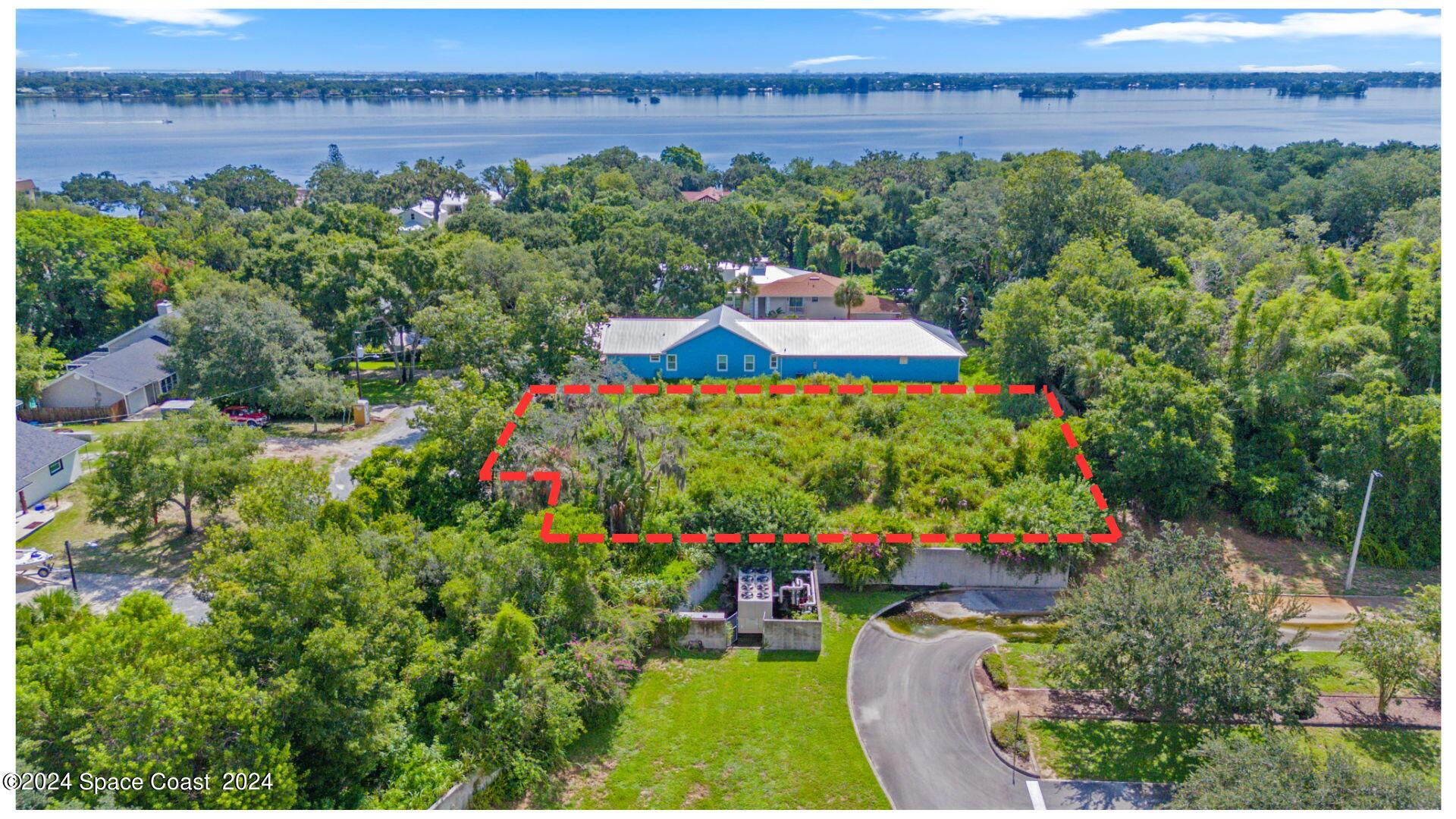 an aerial view of a house a yard and lake view