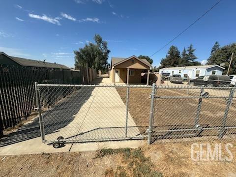 a view of a house with a wooden fence