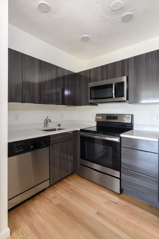 a kitchen with granite countertop a stove and a microwave oven