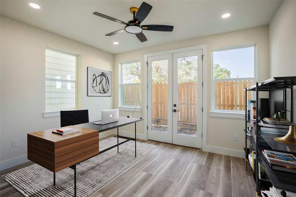 a view of a workspace with furniture and a window