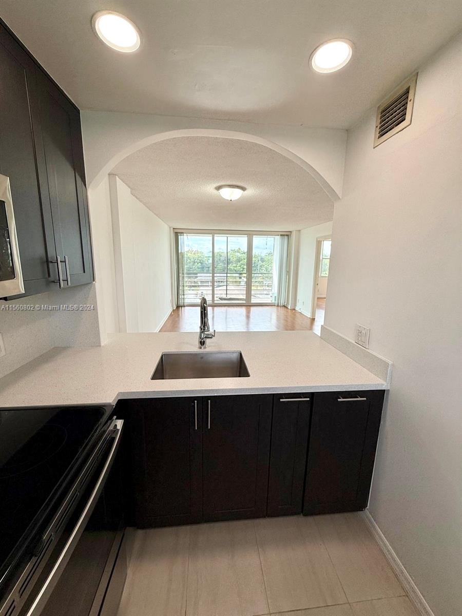 a kitchen with a sink and cabinets