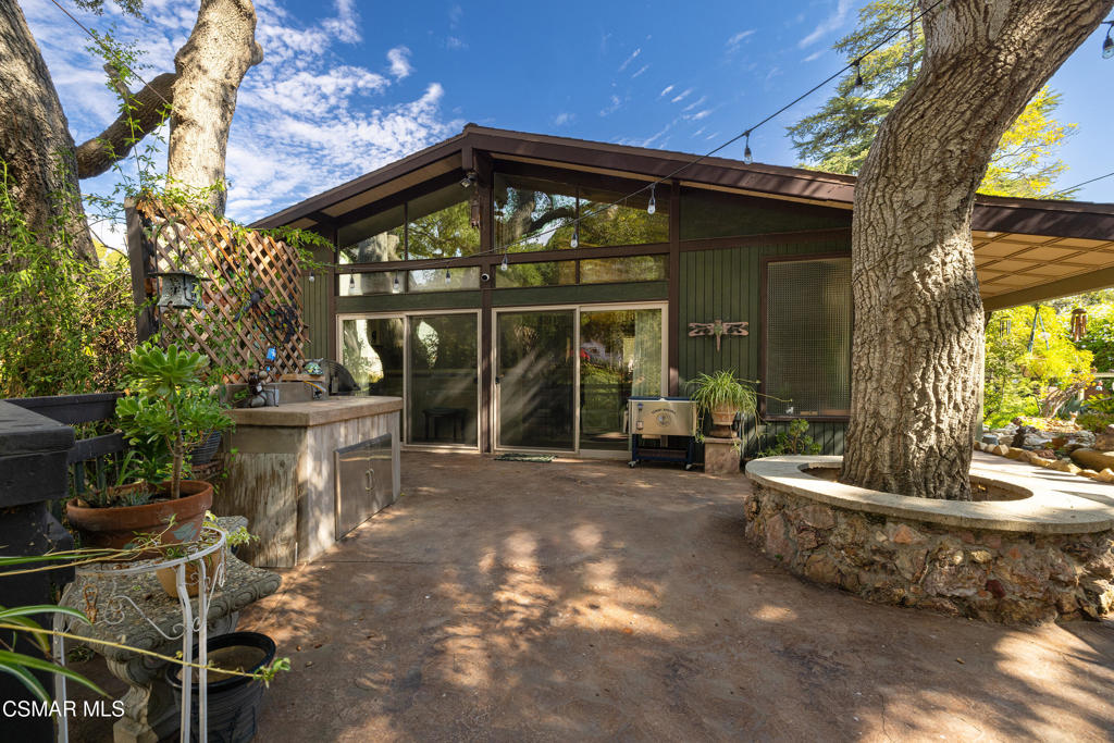 a view of a house with backyard sitting area and porch