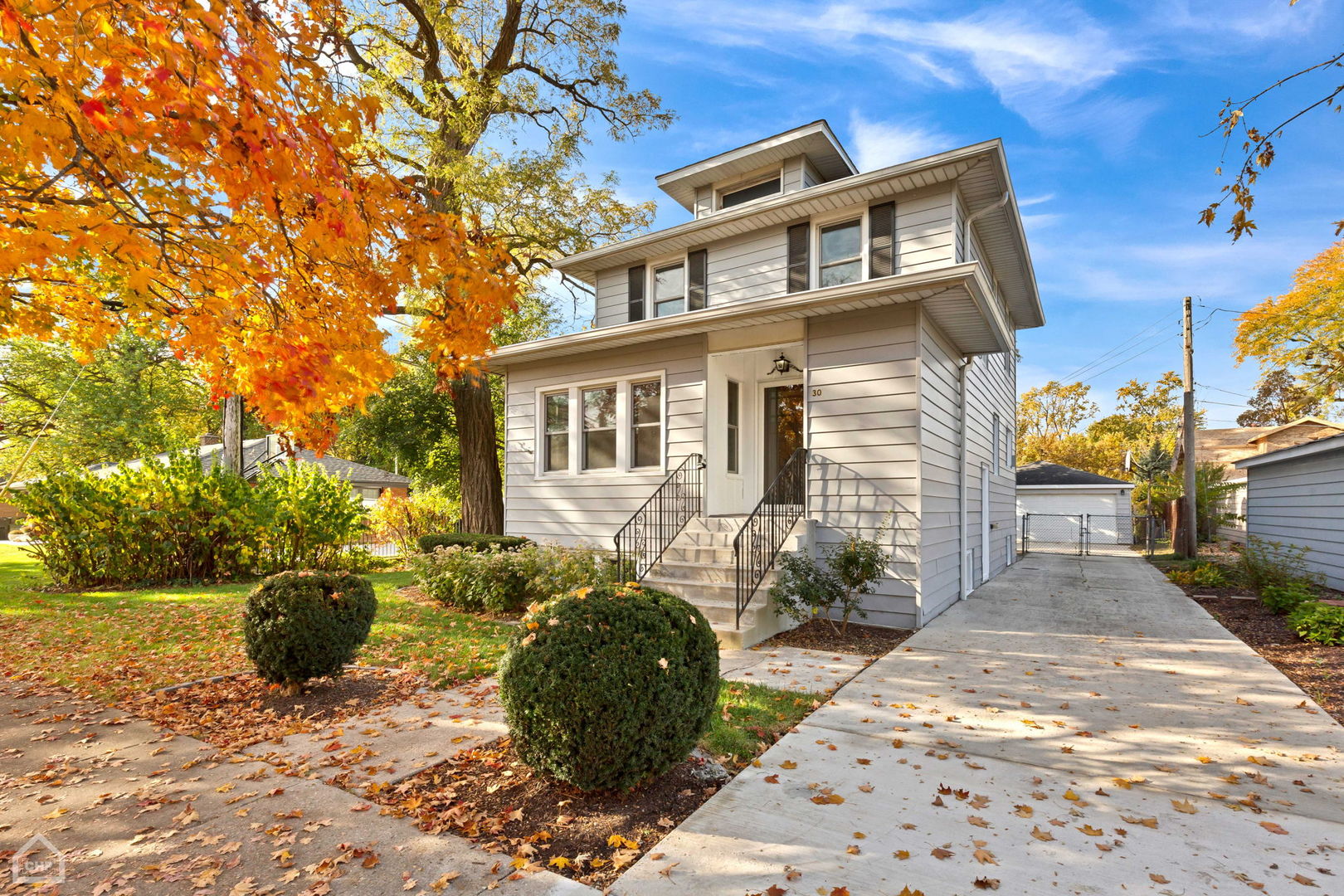 a front view of a house with sitting area