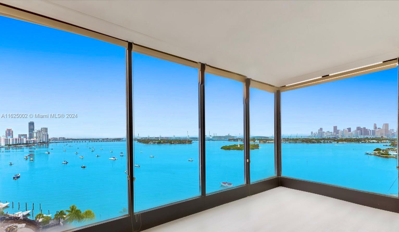 a view of a room with floor to ceiling window and an ocean view