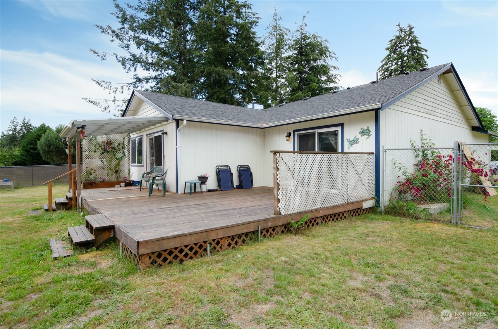 a view of a house with backyard and sitting area