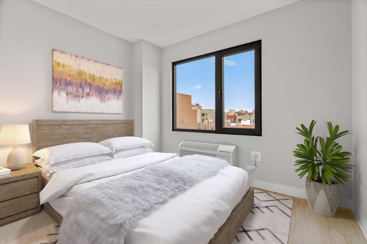 a bedroom with a large bed and a painting on the wall