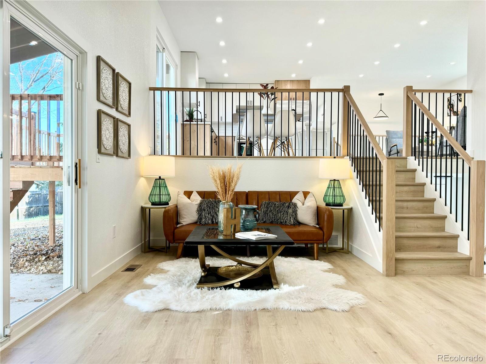 a living room with wooden floor furniture and a book shelf