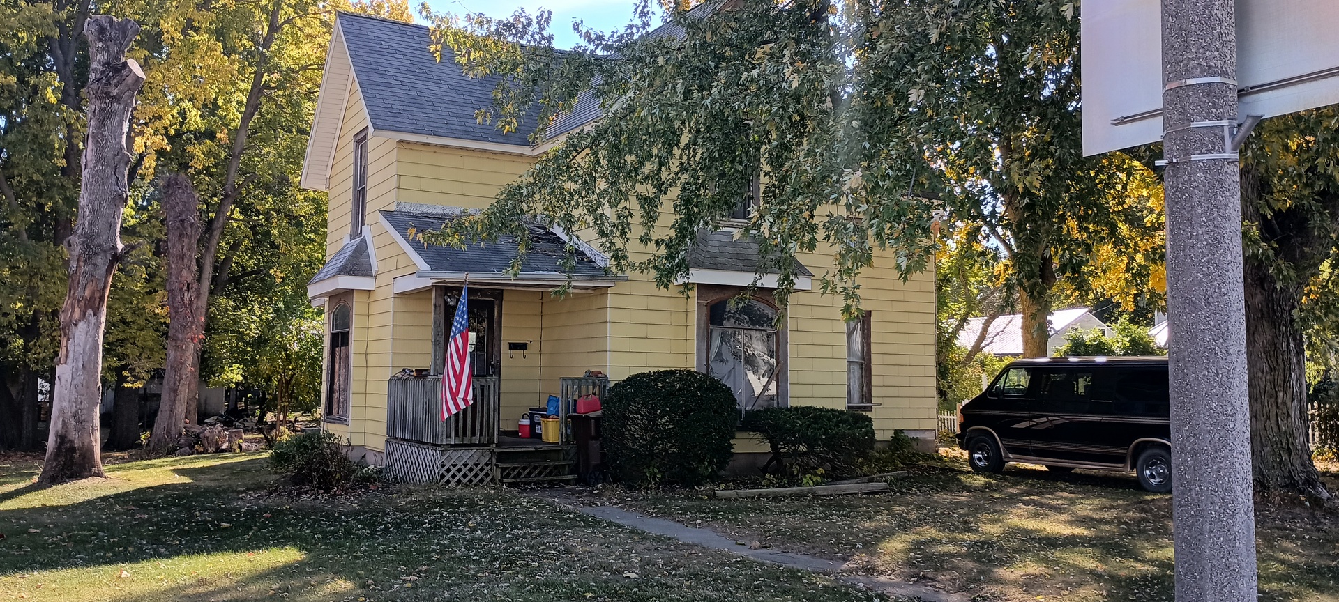 a view of a house with a yard and a patio