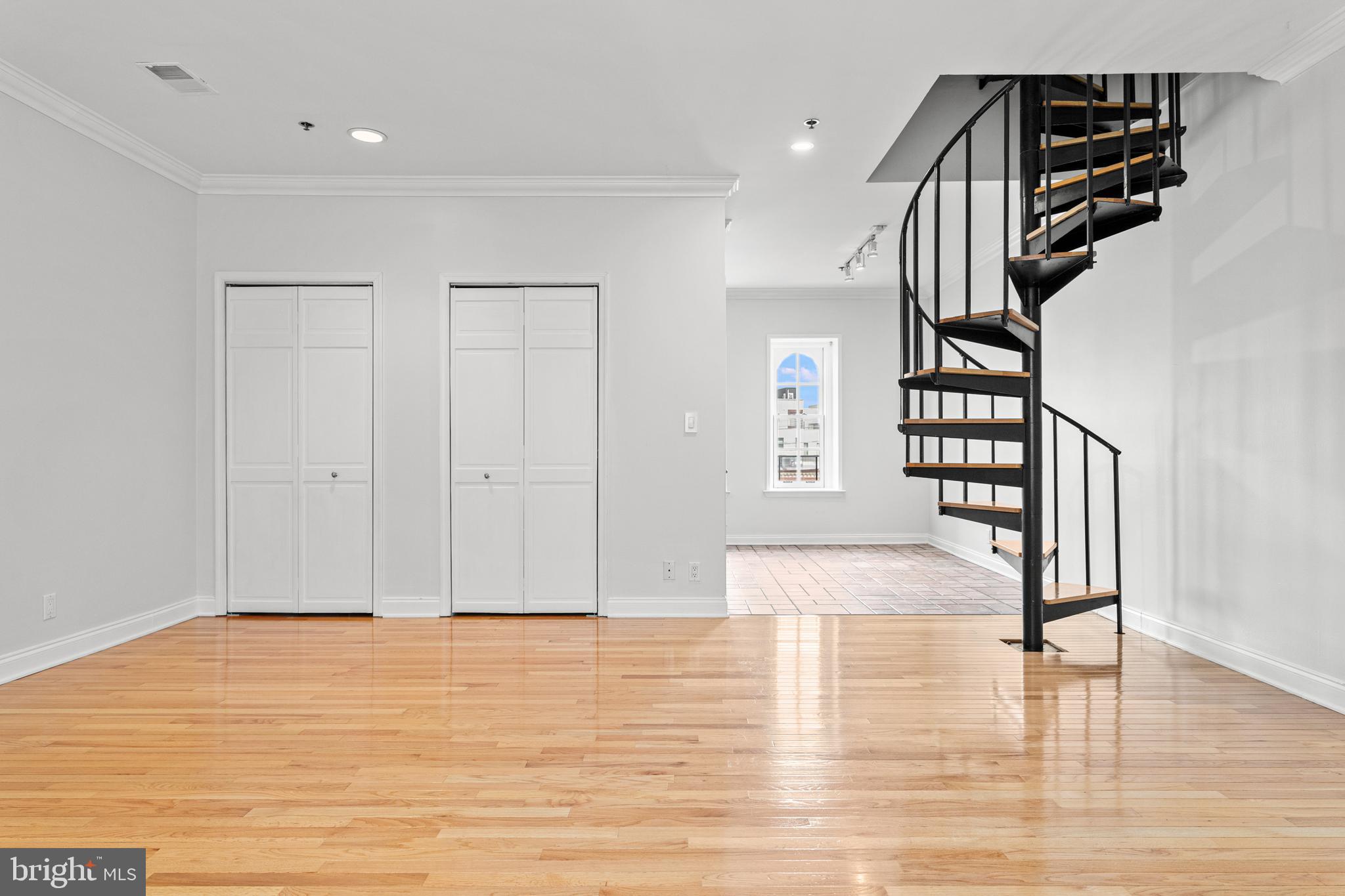 a view of entryway and hall with wooden floor