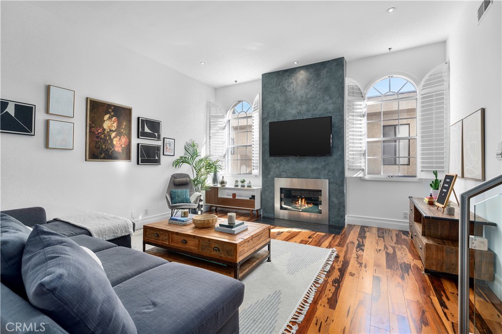 a living room with furniture fireplace and flat screen tv