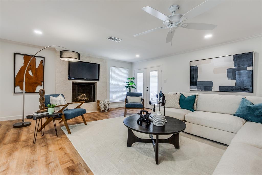 a living room with furniture a fireplace and a flat screen tv