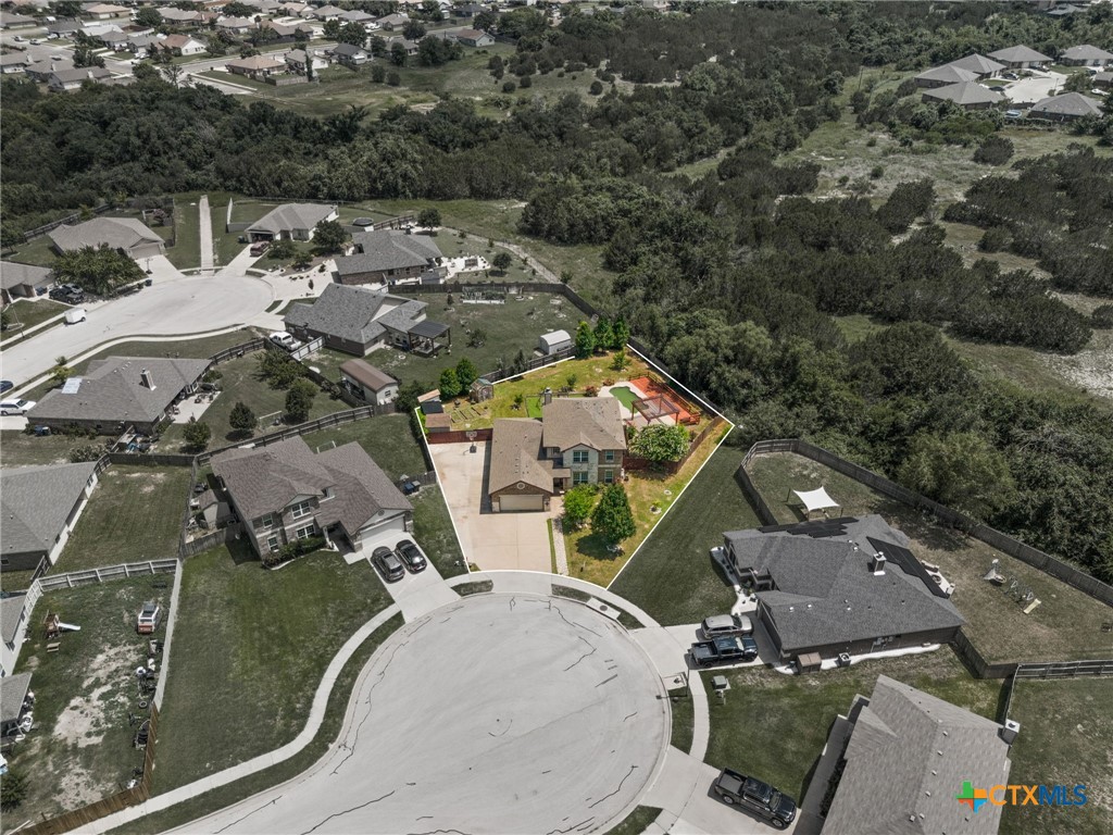 an aerial view of a house with a yard