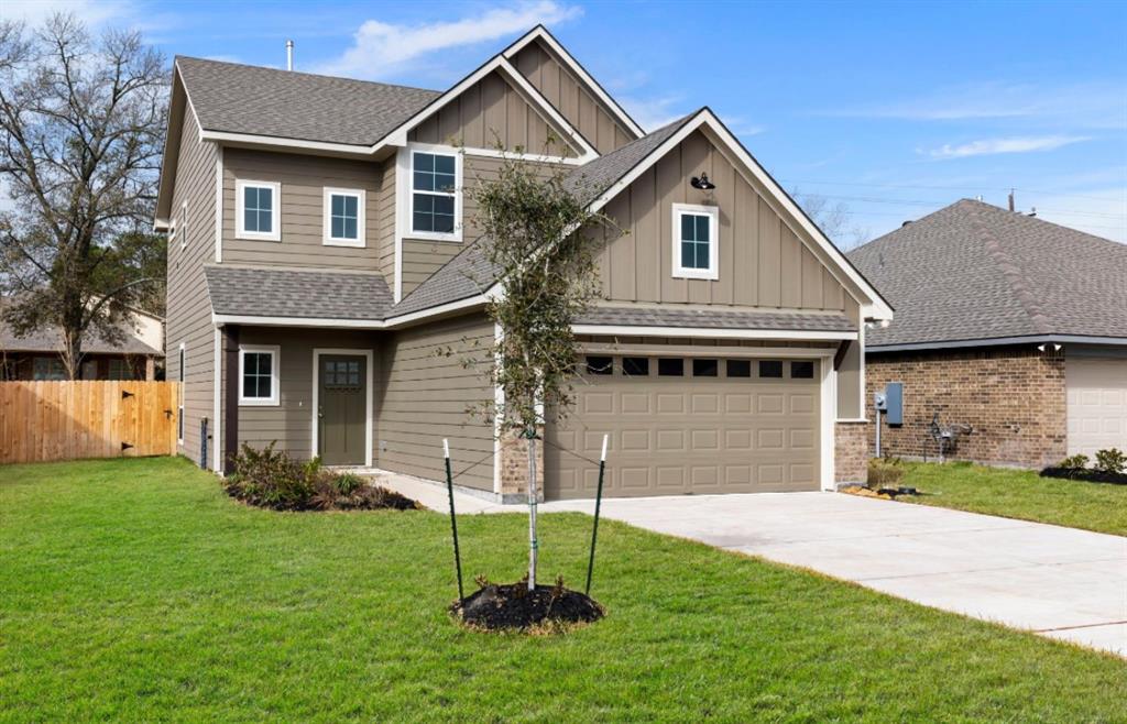 a front view of a house with a yard and garage