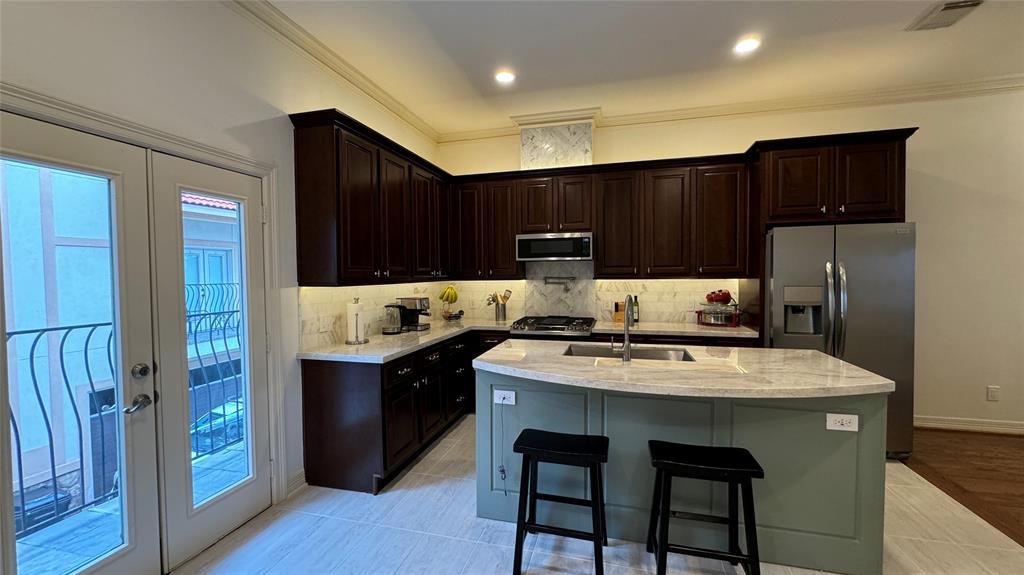 a kitchen with kitchen island a cabinets counter space and appliances