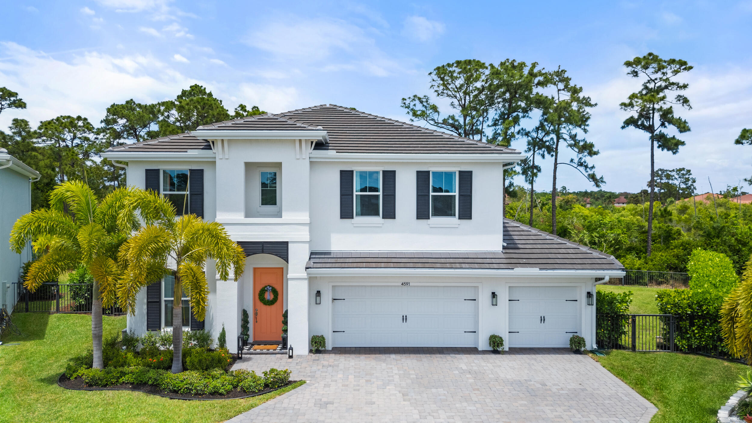 a front view of a house with a garden