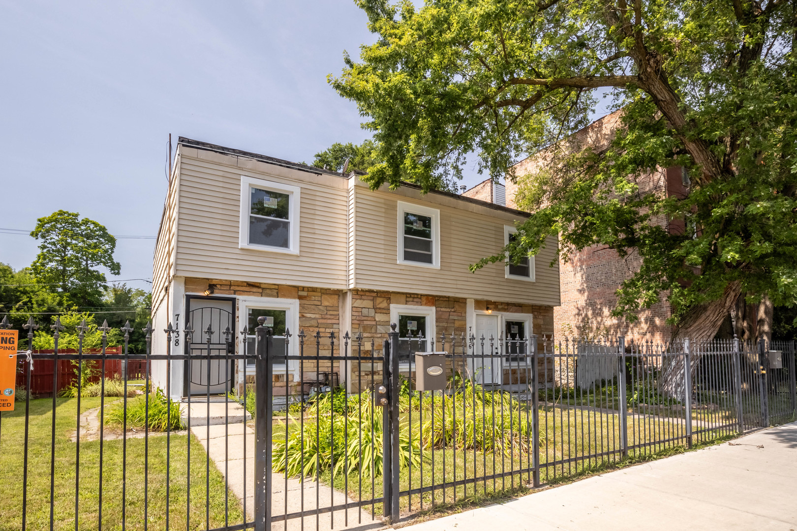 a view of a house with wooden fence