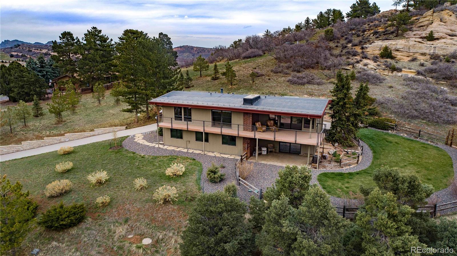 an aerial view of a house with swimming pool and sitting area