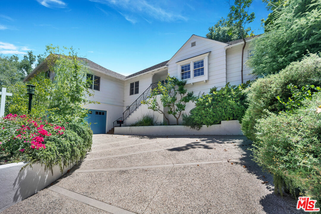 a house with a yard and potted plants