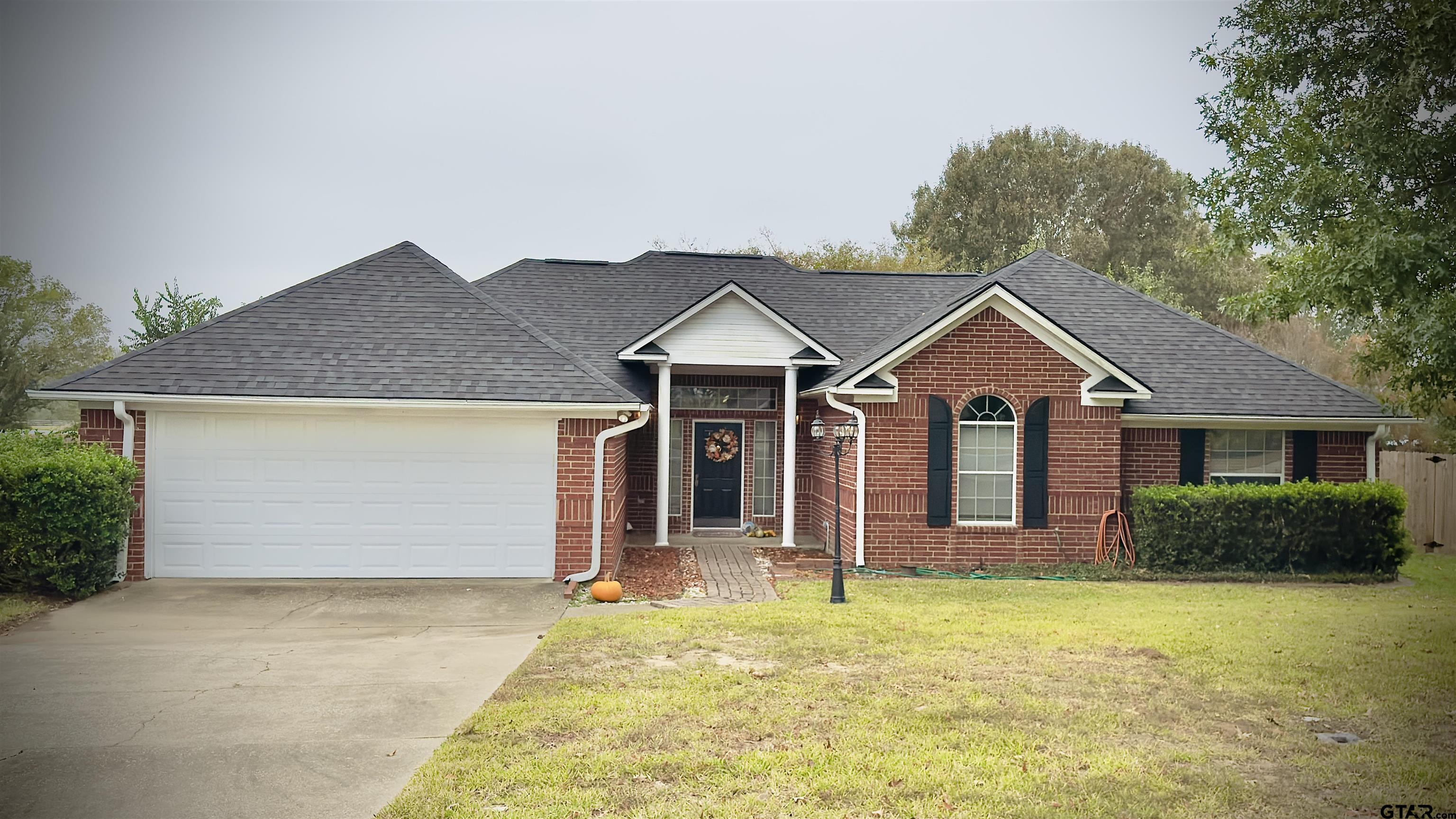 a front view of a house with garden