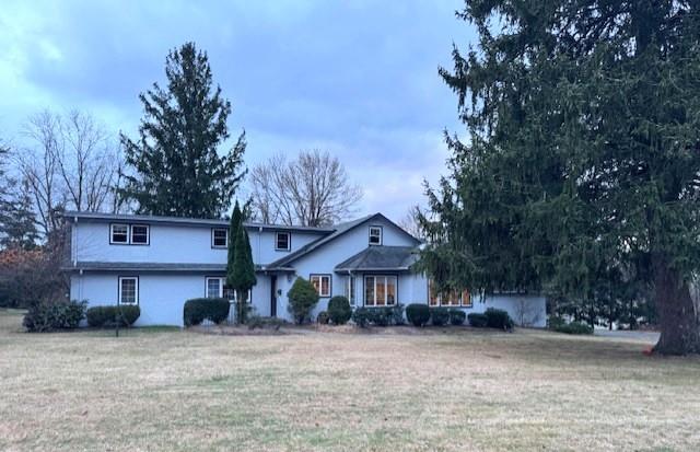 a front view of a house with a yard and a garage