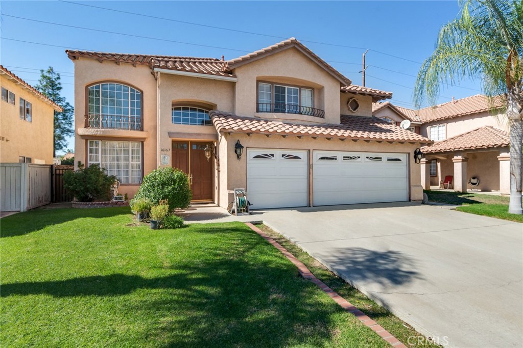 a front view of a house with a yard and garage