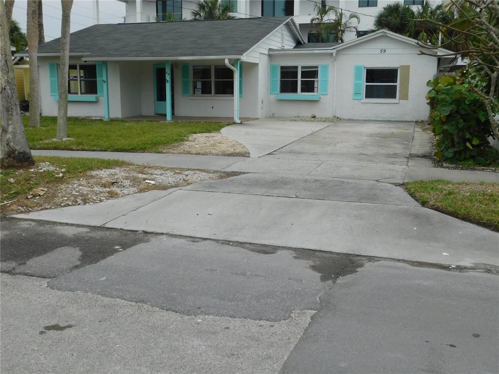 a front view of a house with a yard and a garage