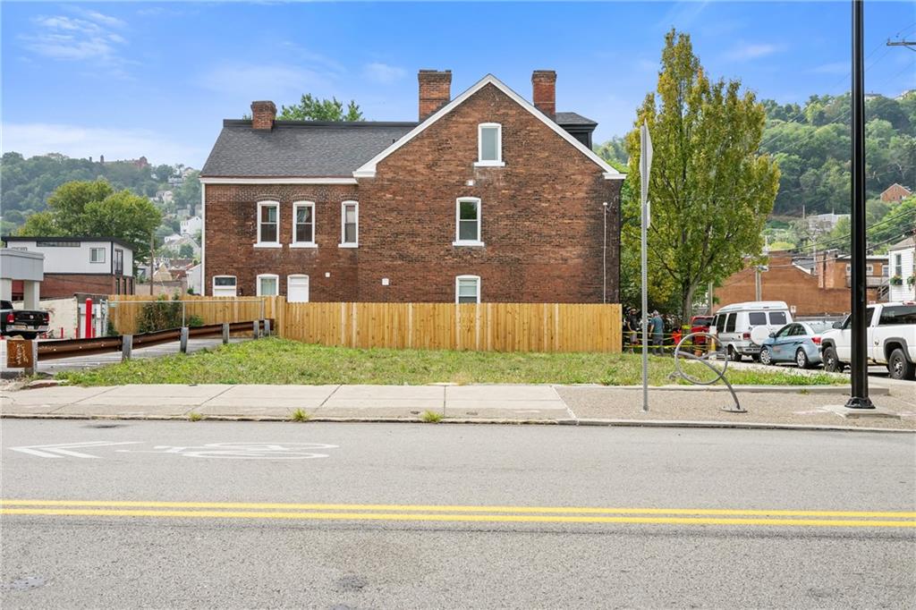 a front view of a house with a yard and a garage