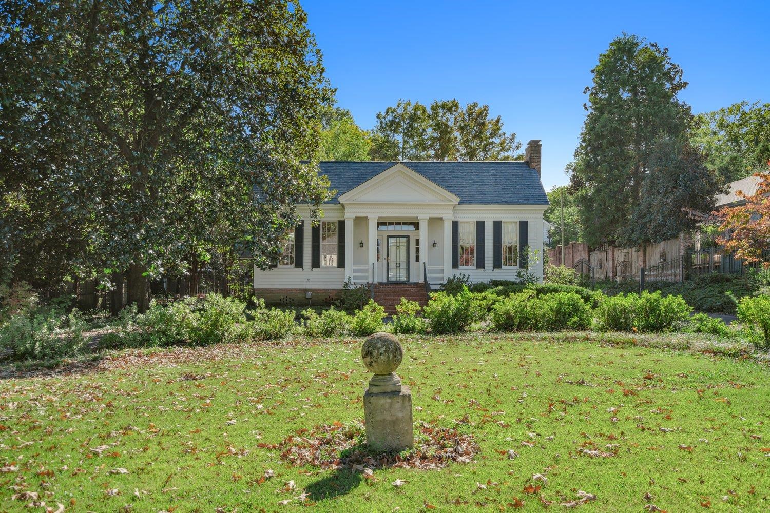 Greek revival house featuring a front lawn