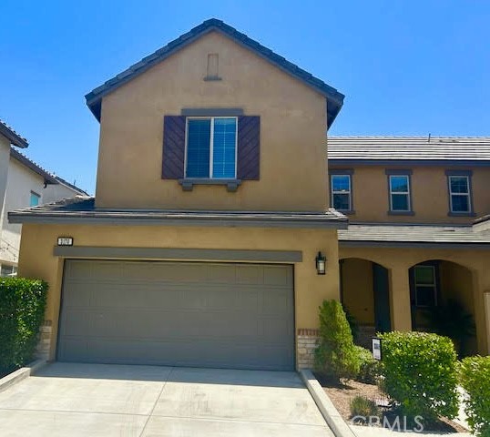 a front view of a house with garage