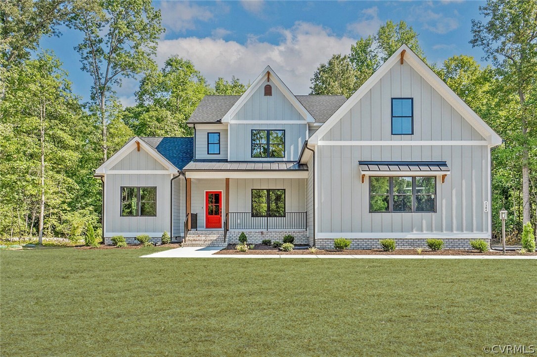 a front view of house with yard and outdoor seating