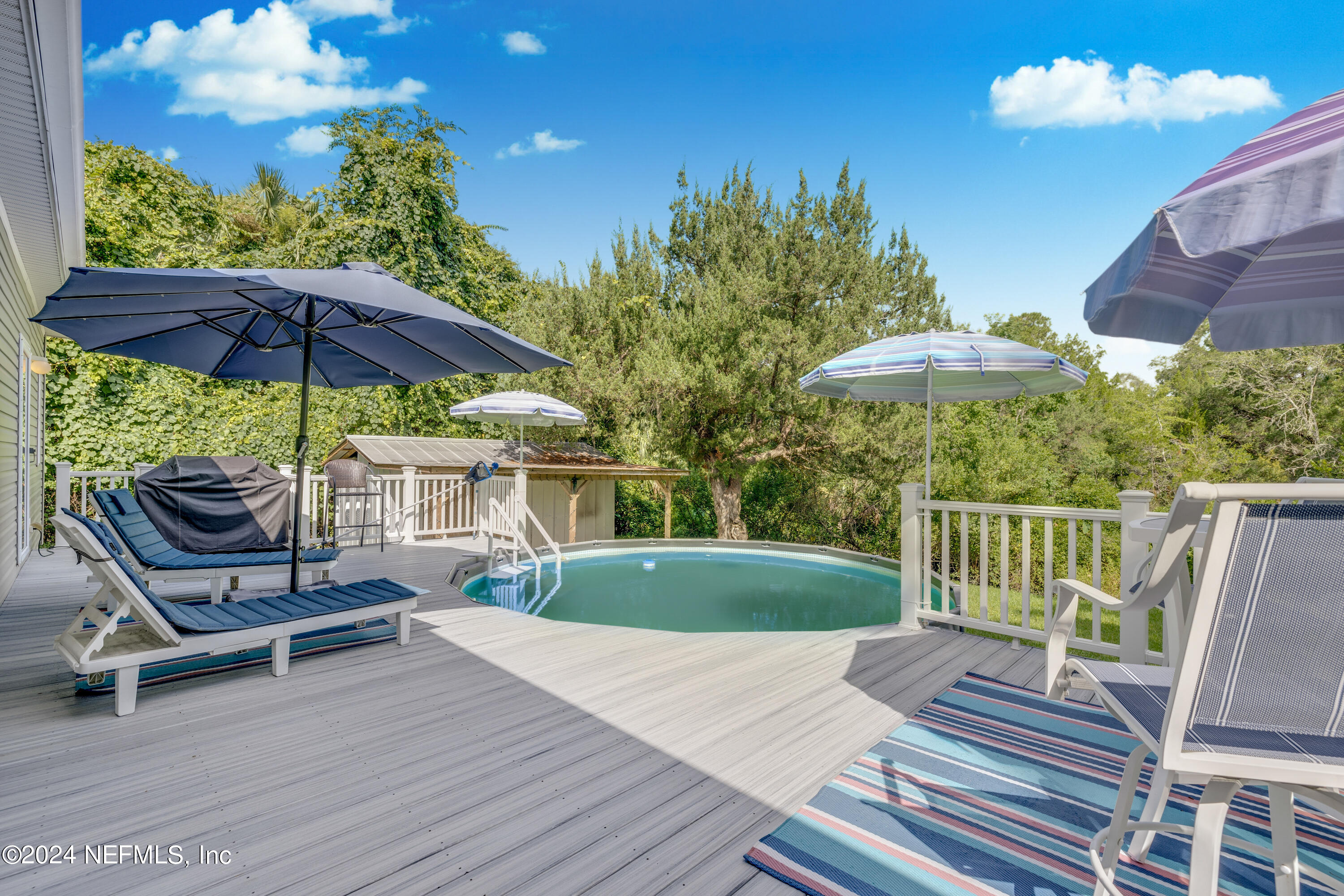 a view of a patio with a table chairs and a umbrella