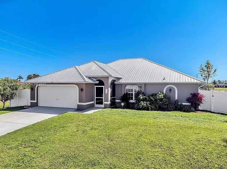 a view of a house with a yard and garage