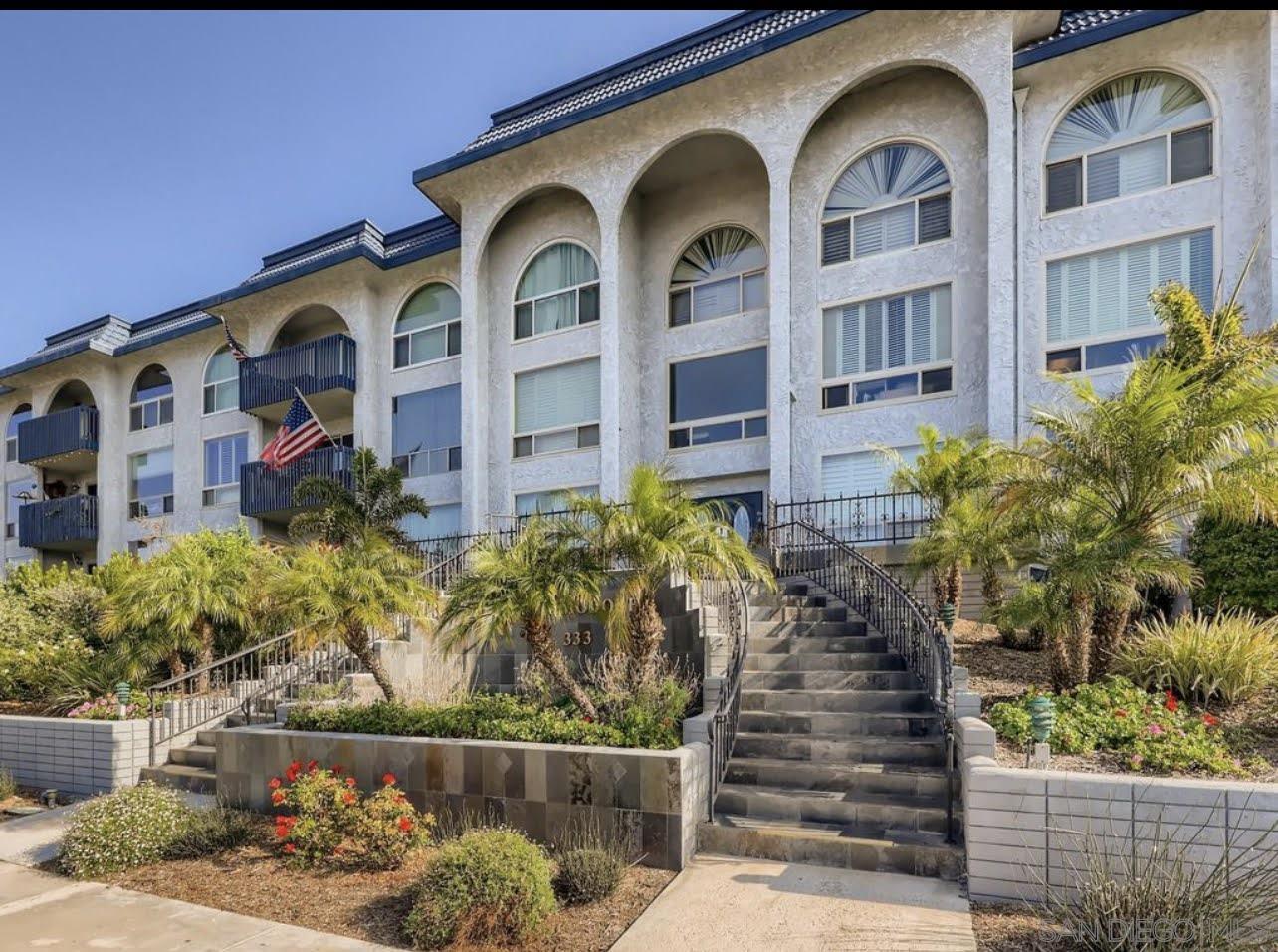 a front view of a multi story residential apartment building with a yard