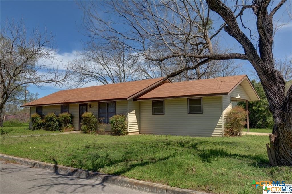 a front view of a house with a yard