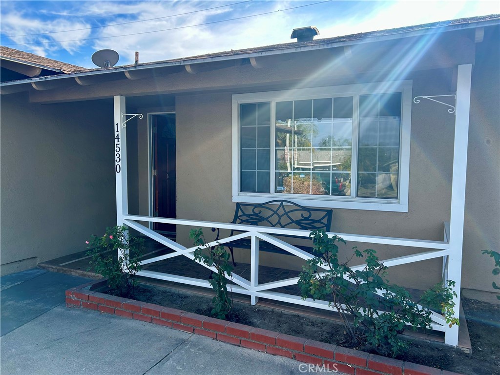 a front view of a house with plants