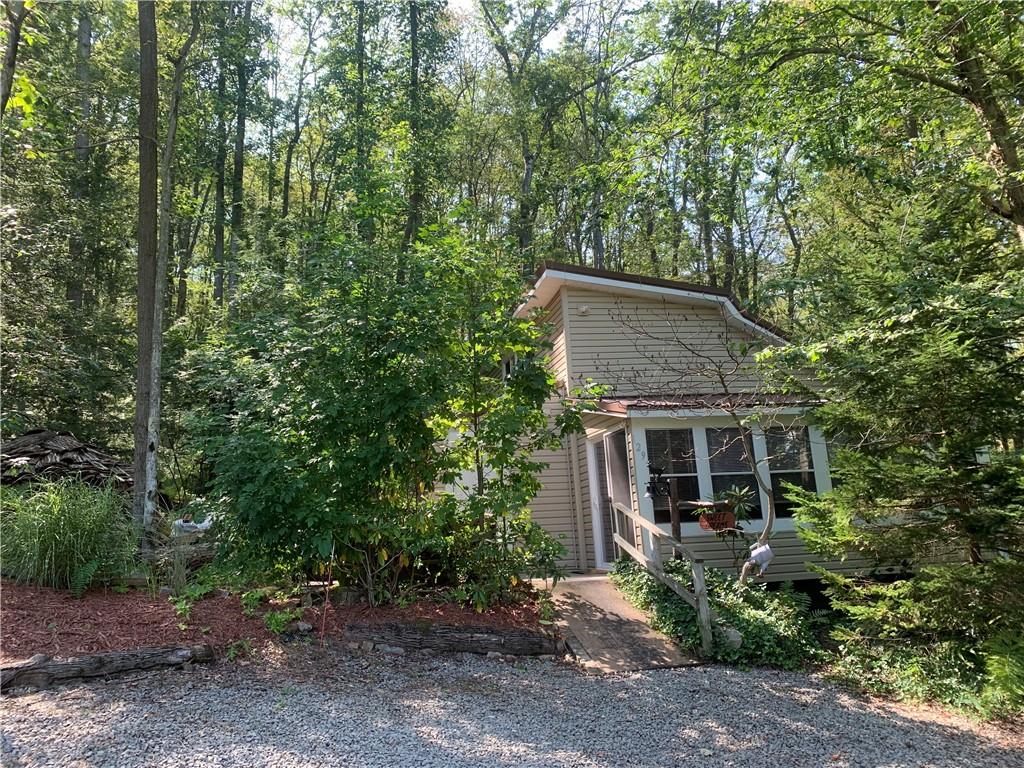 a view of a house with a tree in front of it