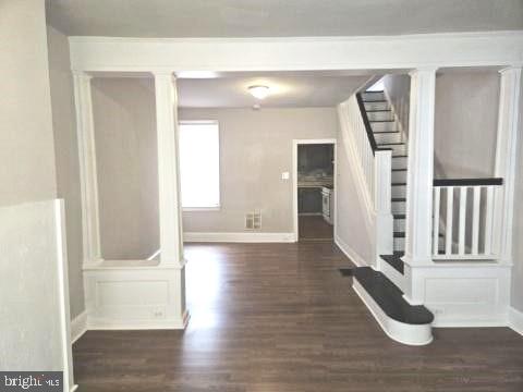 a view of an entryway with wooden floor