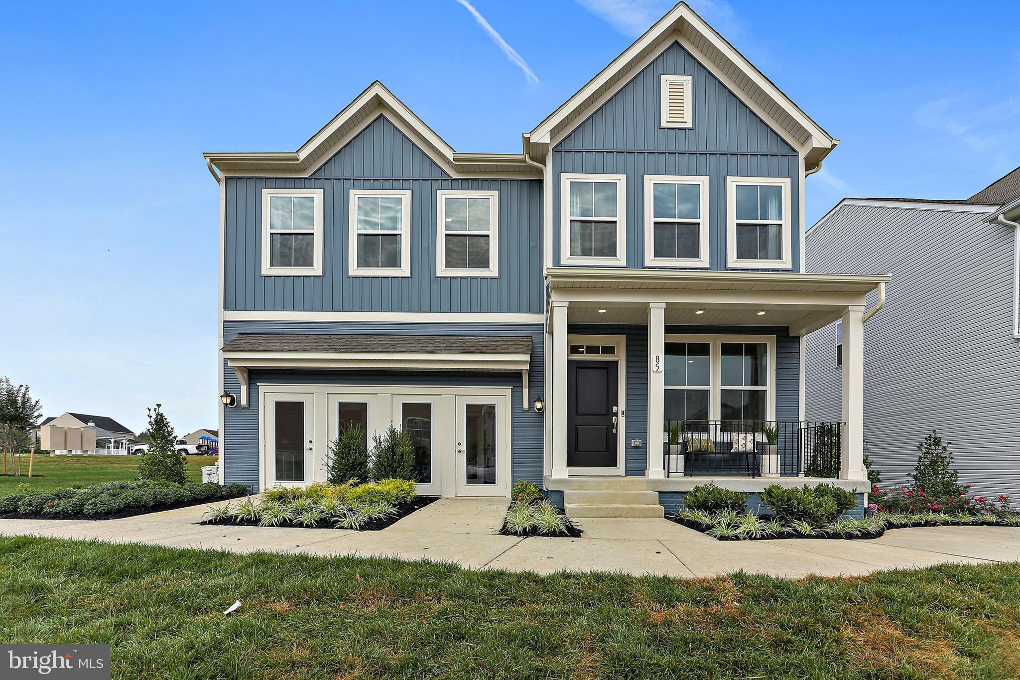 a front view of a house with a yard and plants