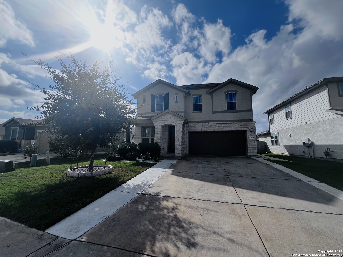 a front view of a house with a yard