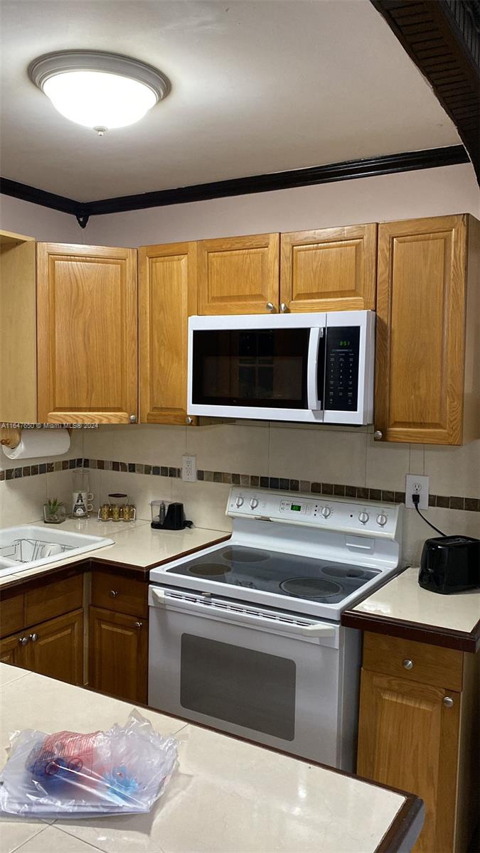 a kitchen with stainless steel appliances granite countertop a sink and a stove