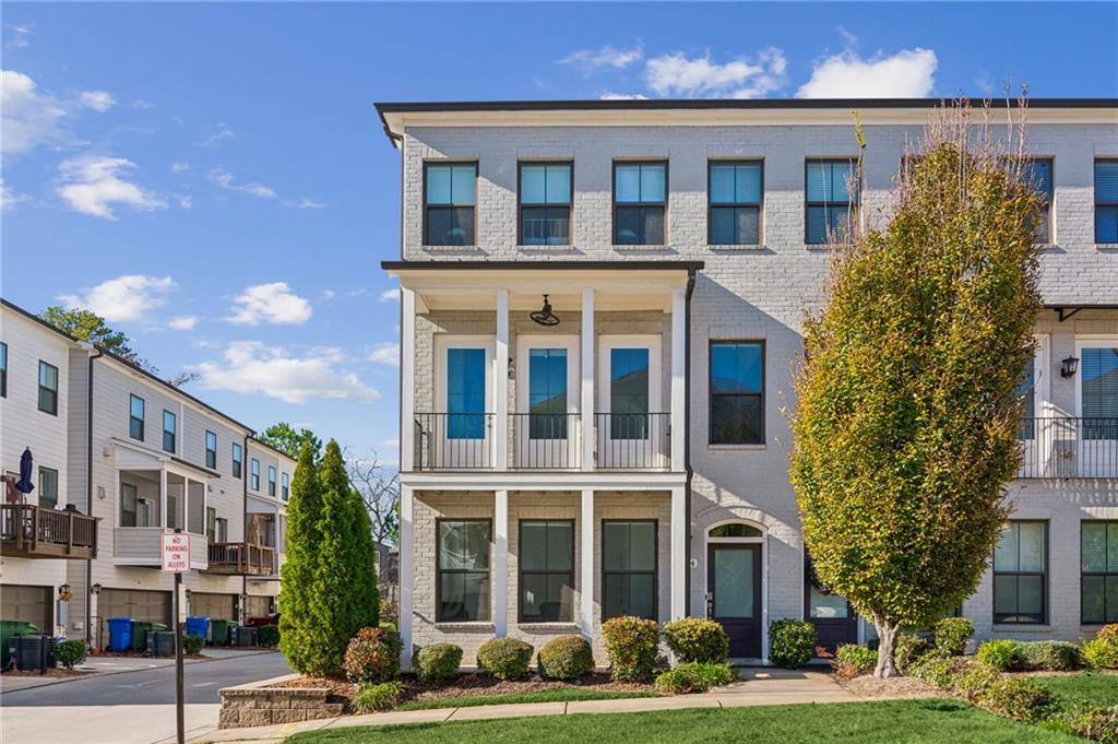 a front view of a residential apartment building with a yard