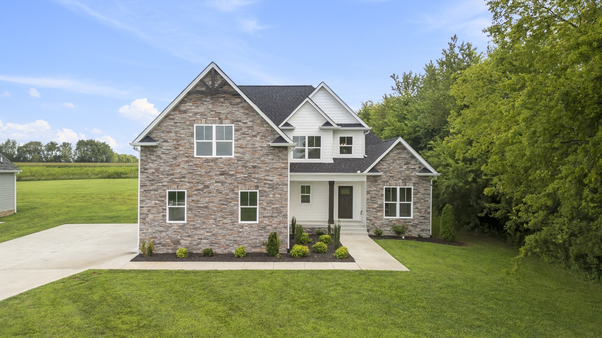 a front view of house with yard and green space