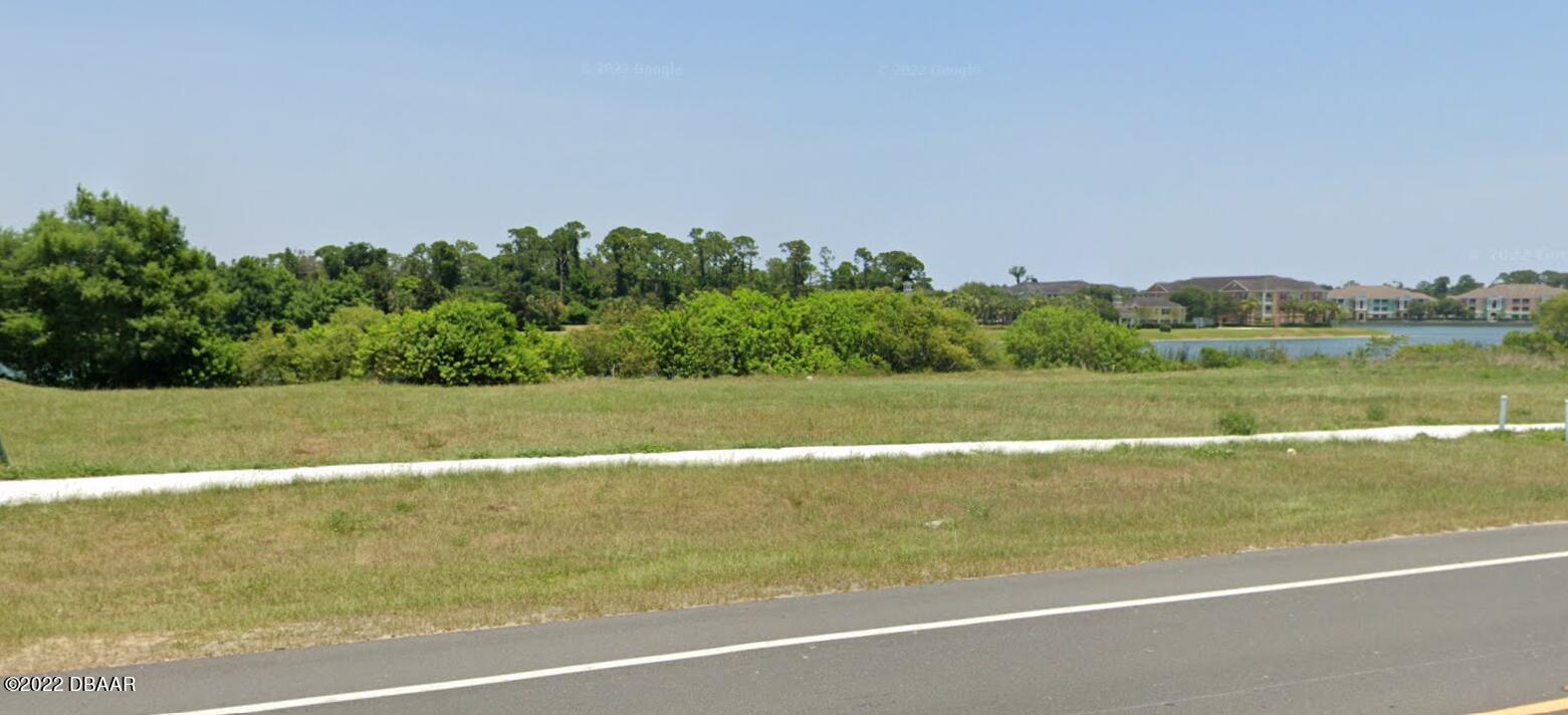 a view of a green field with clear sky