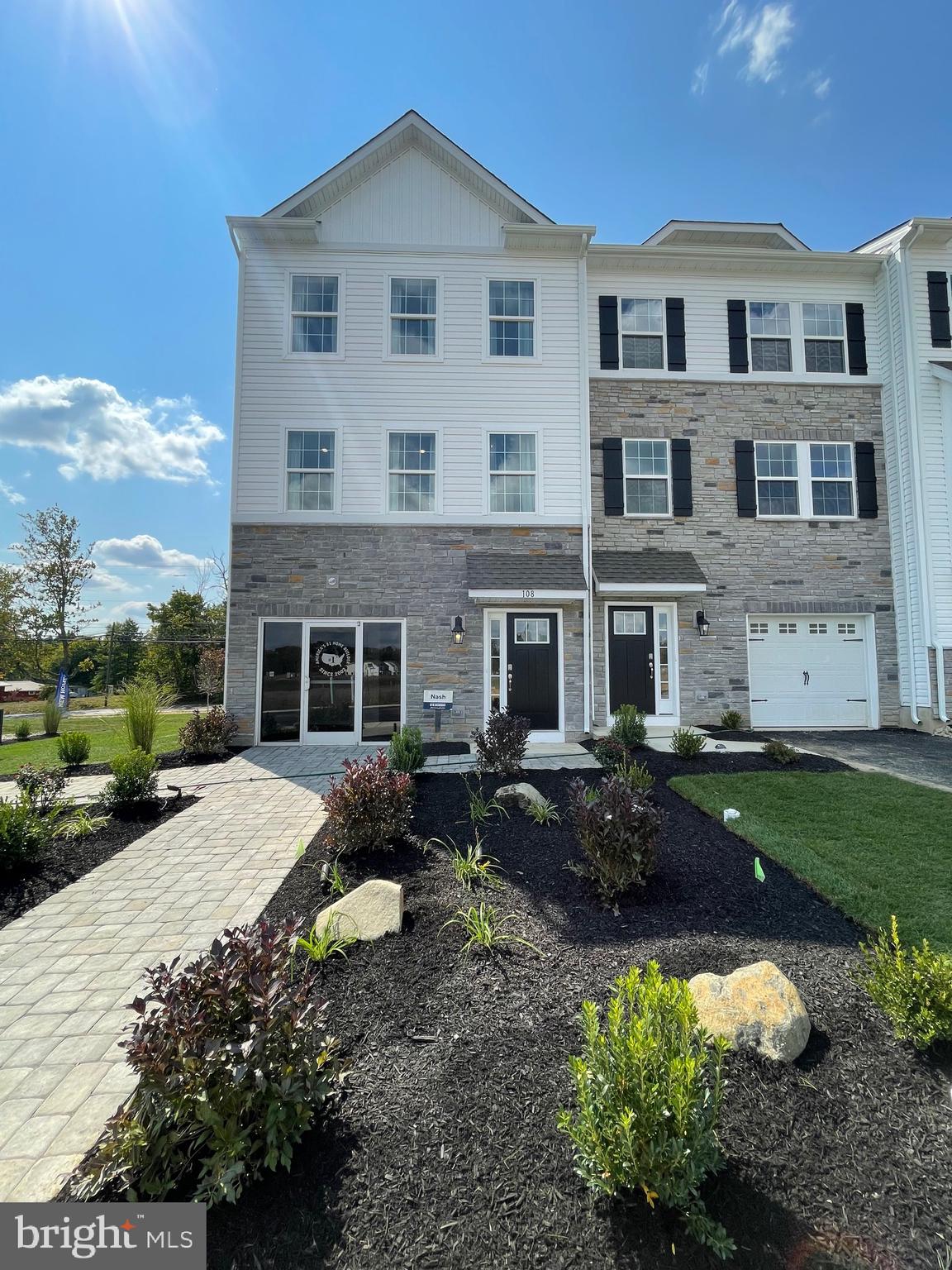 a front view of a house with a garden and patio