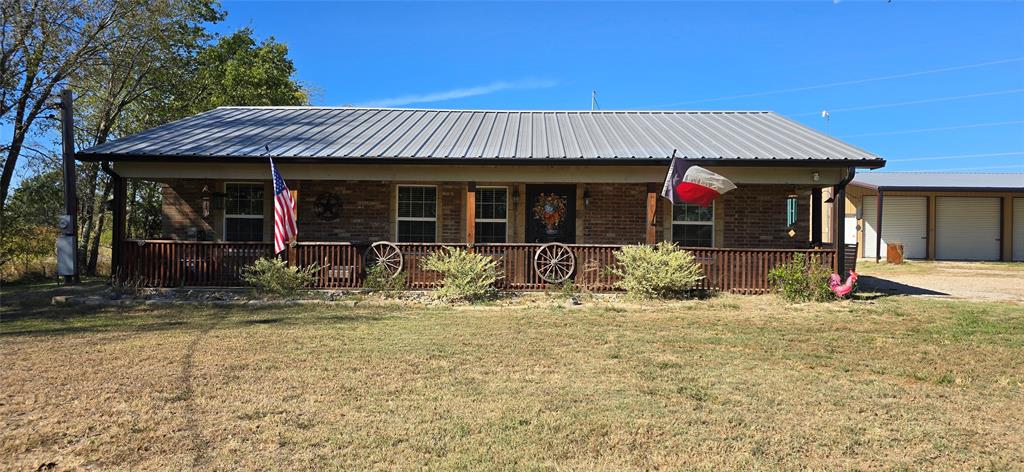 a view of a house with backyard porch and sitting area