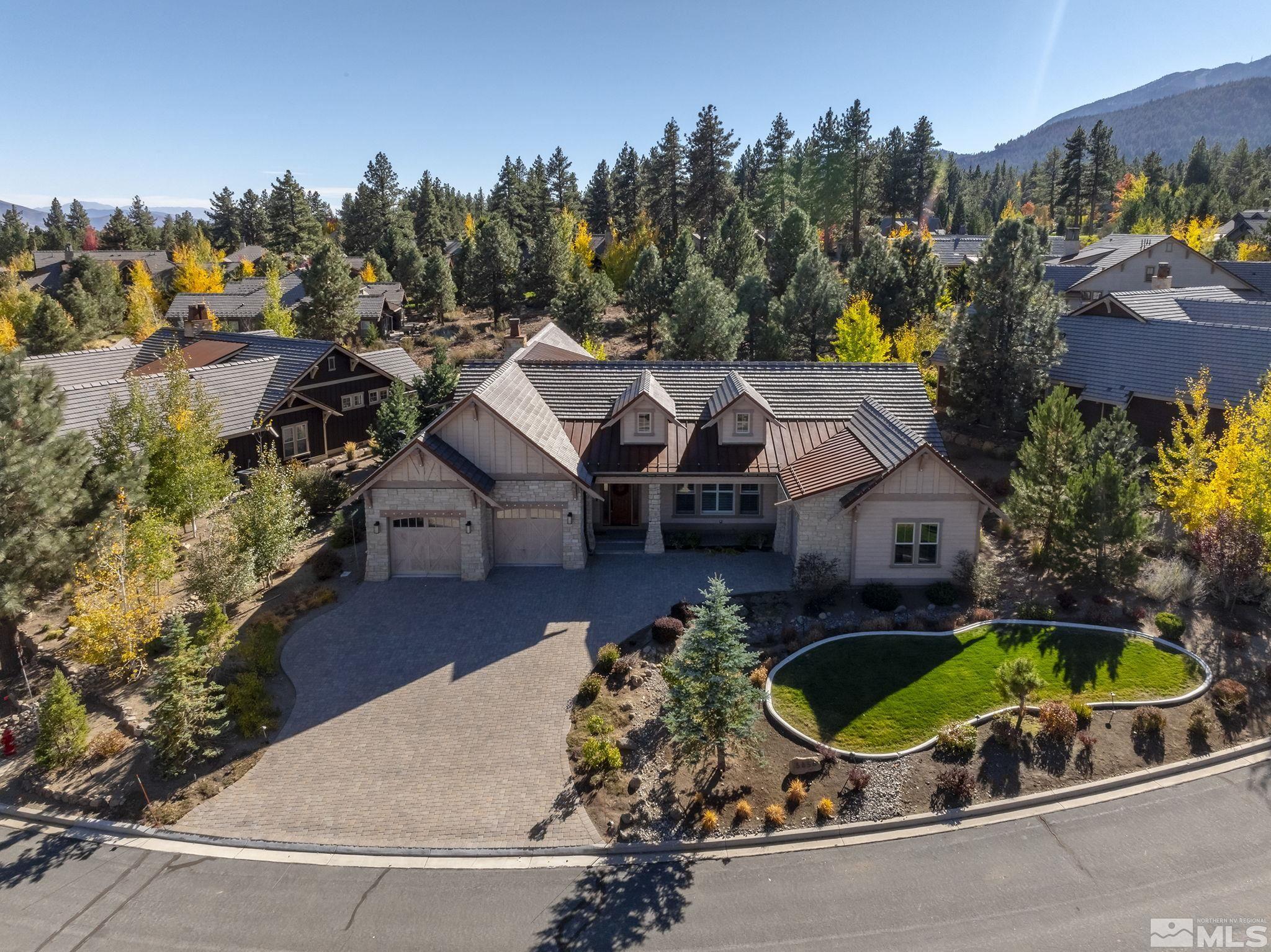 an aerial view of a house with a swimming pool a yard and a fountain